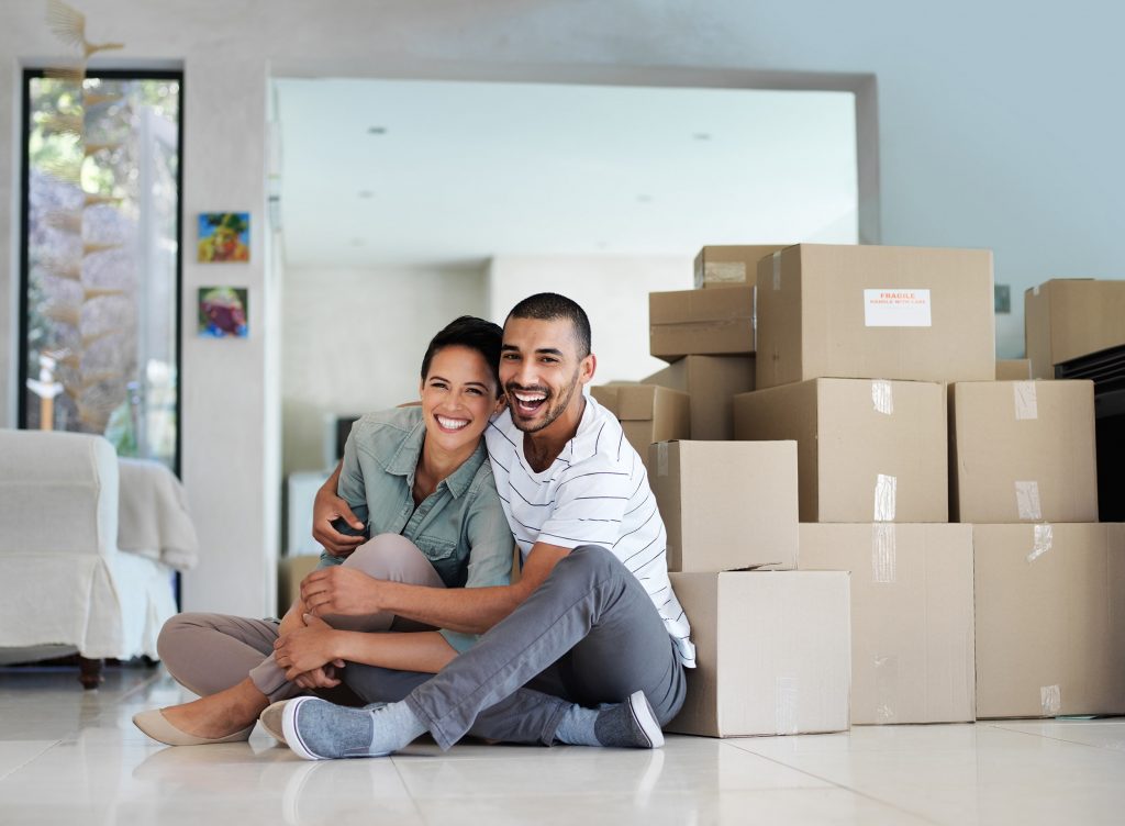 Couple Sitting in Front of Boxes
